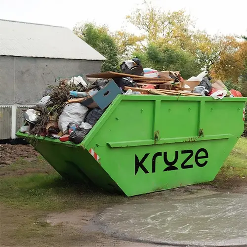 Green skip bin filled with household and construction waste