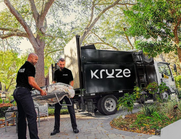Professional junk removal team loading furniture into waste truck